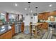 Spacious kitchen with stainless appliances, granite counters, breakfast bar, and white tile backsplash at 2295 Hemrick Rd, Cumming, GA 30041