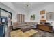 Bright and airy living room with a comfortable sofa, stylish decor, and seamless transition to the adjoining spaces at 2295 Hemrick Rd, Cumming, GA 30041