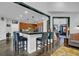 Open concept living area with a breakfast bar, kitchen, and stairway, creating a seamless flow throughout the home at 2295 Hemrick Rd, Cumming, GA 30041