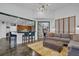 Spacious living area showcasing an open layout with a breakfast bar, modern kitchen, and access to the staircase at 2295 Hemrick Rd, Cumming, GA 30041