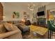 Comfortable living room with a decorative fireplace, plush seating, and modern lighting at 2295 Hemrick Rd, Cumming, GA 30041