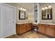 Bright main bathroom with dual sinks, tile floors, ample vanity storage, and linen shelving at 2295 Hemrick Rd, Cumming, GA 30041