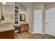 Well-lit bathroom with dual sinks, vanity storage, tile floors, and a built in vanity seat at 2295 Hemrick Rd, Cumming, GA 30041