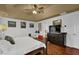 Spacious main bedroom with hardwood floors, large dresser, and a ceiling fan at 2295 Hemrick Rd, Cumming, GA 30041