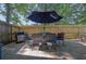 Patio area with an outdoor grill and dining set, perfect for entertaining guests at 2295 Hemrick Rd, Cumming, GA 30041