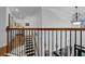 This staircase features hardwood steps, black iron spindles, and a decorative light fixture at 2295 Hemrick Rd, Cumming, GA 30041