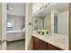 Bathroom featuring double sinks, marble countertops, and a view into the main bedroom at 2310 River Green Nw Dr, Atlanta, GA 30327