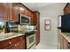 Kitchen featuring stainless steel appliances, sleek black oven, and granite countertops at 2310 River Green Nw Dr, Atlanta, GA 30327