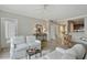 Bright living room with neutral tones, ceiling fan, comfortable seating, and view of dining area at 2310 River Green Nw Dr, Atlanta, GA 30327