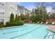Refreshing swimming pool with lounge chairs, surrounded by lush landscaping in a condominium complex at 2310 River Green Nw Dr, Atlanta, GA 30327