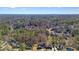 Aerial view of a home nestled among lush trees in a quiet, residential neighborhood at 9470 Dominion Way, Alpharetta, GA 30022