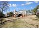 Expansive backyard view showcasing the home's architecture and outdoor space with a two-story deck at 9470 Dominion Way, Alpharetta, GA 30022