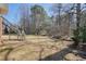 Backyard featuring a tiered deck, spacious lawn, and mature trees providing privacy at 9470 Dominion Way, Alpharetta, GA 30022