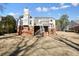 Expansive backyard view showcasing the home's architecture and outdoor space with a two-story deck at 9470 Dominion Way, Alpharetta, GA 30022