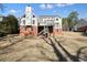 Expansive backyard view showcasing the home's architecture and outdoor space with a two-story deck at 9470 Dominion Way, Alpharetta, GA 30022