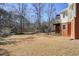 A wide shot of an expansive backyard with lush lawn, treeline, and a deck overlooking the scenic landscape at 9470 Dominion Way, Alpharetta, GA 30022