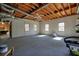 A large unfinished basement featuring a ceiling fan and multiple windows, offering lots of natural light at 9470 Dominion Way, Alpharetta, GA 30022