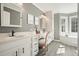 Elegant bathroom with white double sink vanity, sleek hardware, framed mirrors, and custom lighting at 9470 Dominion Way, Alpharetta, GA 30022