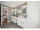 Stylish bathroom featuring double sink vanity, sleek hardware, framed mirrors, and decorative lighting at 9470 Dominion Way, Alpharetta, GA 30022