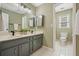 Bathroom with dual vanity and cabinet storage at 9470 Dominion Way, Alpharetta, GA 30022