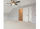 Bedroom featuring neutral carpet, an overhead fan, and a closet with sliding doors at 9470 Dominion Way, Alpharetta, GA 30022