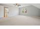 Bedroom featuring neutral carpet, an overhead fan, and a view to a window at 9470 Dominion Way, Alpharetta, GA 30022