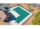 Aerial shot of a community pool with a green cover, adjacent to a clubhouse and well-kept grounds at 9470 Dominion Way, Alpharetta, GA 30022