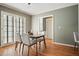 Dining room with hardwood floors, natural light, with French doors and view to another room at 9470 Dominion Way, Alpharetta, GA 30022