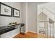 Inviting foyer area with gleaming hardwood floors and a view into the living room with vaulted ceilings and a fireplace at 9470 Dominion Way, Alpharetta, GA 30022