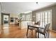 Bright kitchen open to the dining area with hardwood floors, island seating, stainless appliances, and natural light at 9470 Dominion Way, Alpharetta, GA 30022