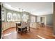 Spacious kitchen and dining area with hardwood floors, island seating, stainless appliances, and access to the patio at 9470 Dominion Way, Alpharetta, GA 30022