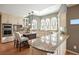 Kitchen features granite countertops, stainless appliances, and a breakfast bar with counter seating under pendant lights at 9470 Dominion Way, Alpharetta, GA 30022