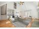 Stylish living room with high ceilings, hardwood floors, fireplace, and a bar area at 9470 Dominion Way, Alpharetta, GA 30022