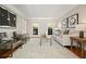 Bright living room with hardwood floors, neutral walls, sofa, and a statement art piece at 9470 Dominion Way, Alpharetta, GA 30022