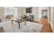 Comfortable living room with hardwood floors, neutral walls, an area rug and natural light at 9470 Dominion Way, Alpharetta, GA 30022