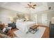 Cozy main bedroom with a tray ceiling, hardwood floors, a plush rug, and large windows for natural light at 9470 Dominion Way, Alpharetta, GA 30022