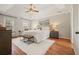 Spacious main bedroom with a tray ceiling, hardwood floors, a plush rug, and large windows for natural light at 9470 Dominion Way, Alpharetta, GA 30022