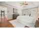 Charming main bedroom featuring hardwood floors, a plush rug, and large windows for ample natural light at 9470 Dominion Way, Alpharetta, GA 30022