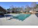 Community pool covered for the off season, and clubhouse in the background at 9470 Dominion Way, Alpharetta, GA 30022