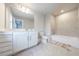 Bright bathroom features double vanity, tiled shower-tub combination, and neutral color palette at 3152 Quinn Pl, Atlanta, GA 30341