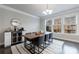 Bright dining room with a modern table, chandelier and bar area with a wine fridge at 3152 Quinn Pl, Atlanta, GA 30341