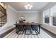 Beautiful dining area featuring a modern table, chandelier, and stairs to upper level at 3152 Quinn Pl, Atlanta, GA 30341