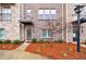 Exterior view of a townhouse featuring a brick facade, bushes and pine straw at 3152 Quinn Pl, Atlanta, GA 30341