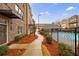 Brick townhouse exterior featuring a walkway, tasteful landscaping, and a glimpse of the community pool at 3152 Quinn Pl, Atlanta, GA 30341