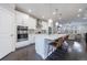 Bright, open kitchen with stainless steel appliances, large island, and modern pendant lighting at 3152 Quinn Pl, Atlanta, GA 30341