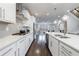 Modern kitchen with white cabinetry, stainless steel appliances, and a center island open to living areas at 3152 Quinn Pl, Atlanta, GA 30341