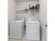 Functional laundry room with washer, dryer, and wire shelving for storage at 3152 Quinn Pl, Atlanta, GA 30341