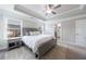 Bright main bedroom features a tray ceiling, windows, and neutral decor at 3152 Quinn Pl, Atlanta, GA 30341