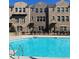 Stunning community pool with a view of modern brick townhomes on a sunny day at 3152 Quinn Pl, Atlanta, GA 30341