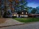 View of a two-story home with a well-manicured lawn and a driveway during twilight hours at 2814 Lloyd Rd, Decatur, GA 30034